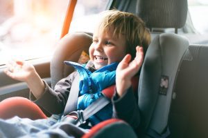 happy child in car seat